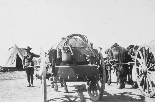 A horse-drawn water cart (tank) mark II (commonly known as a Furphy, after the Australian version manufactured in Ballarat) at a 1st AIF encampment. A second cart pulled by two draught horses is partly visible at right. Egypt, 1915. 